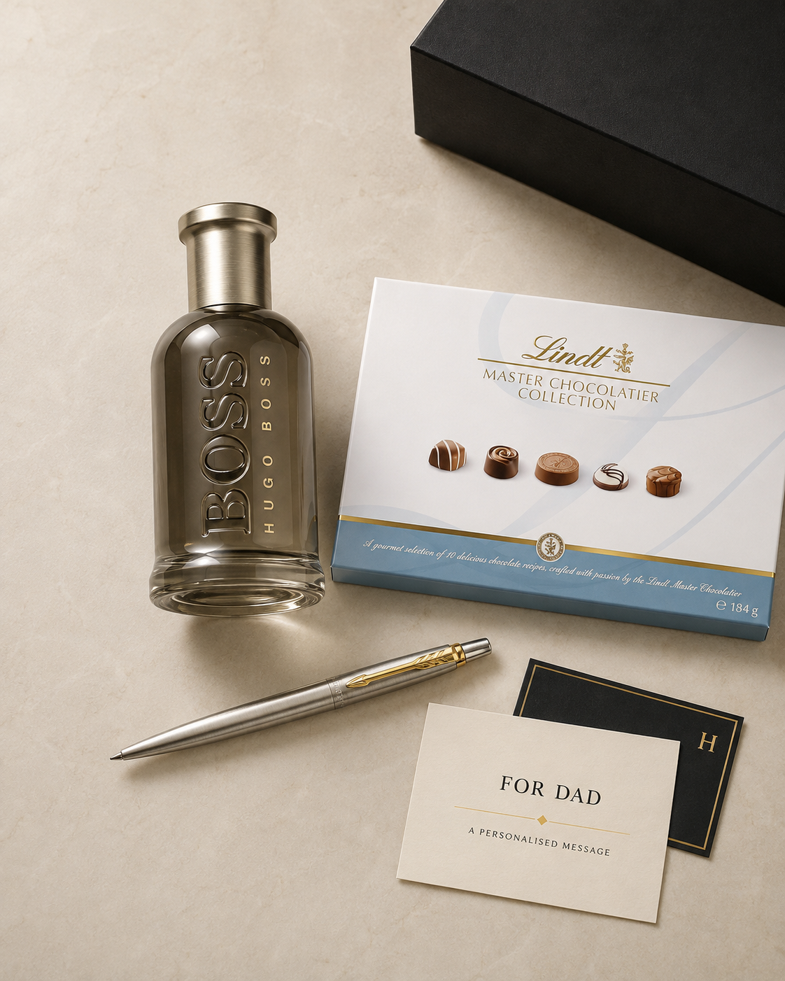 The Reserve Father’s Day gift with Boss Bottled EDP, Gold Parker Jotter, Lindt Master Chocolatier Collection, a personalised keepsake and Hamilton presentation box